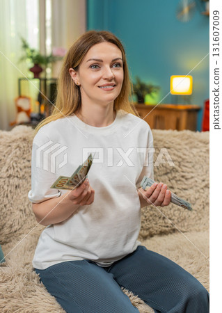 Pregnant woman counts dollars cash planning baby birth budget serious money management preparation Pregnant woman counts dollars cash planning baby birth budget serious money management preparation 131607009