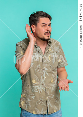 Adult man trying hear you looking confused and frowning, keeping arm near ear for louder voice Adult man trying hear you looking confused and frowning, keeping arm near ear for louder voice 131607055