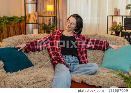Happy woman arranging decorative pillows at home, satisfaction while admiring clean living space Happy woman arranging decorative pillows at home, satisfaction while admiring clean living space 131607099