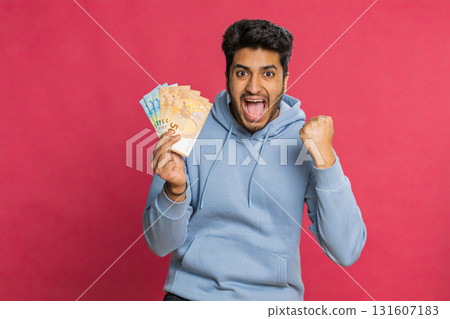 Happy Indian young man holding euro cash counting money showing profit salary or bank loan success 131607183