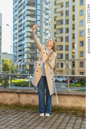 Mature female trying to catch a communication signal or Internet on mobile phone on downtown street Mature female trying to catch a communication signal or Internet on mobile phone on downtown street 131607194