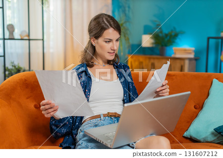 Woman freelancer accountant working with financial documents charts graph reports calculate taxes 131607212