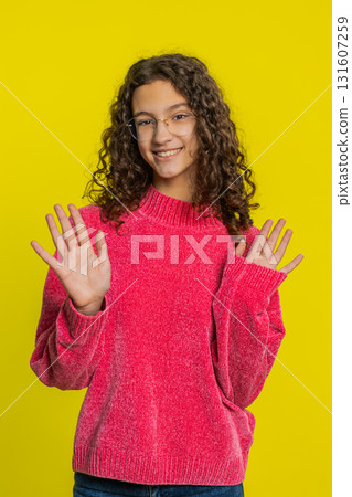 Happy girl smiling friendly waving hands gesturing hello greeting or goodbye, meeting invitation Happy girl smiling friendly waving hands gesturing hello greeting or goodbye, meeting invitation 131607259