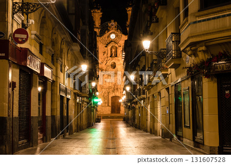 The old town of San Sebastian, Spain, before dawn: deserted cobblestone streets, streetlights and historic buildings The old town of San Sebastian, Spain, before dawn: deserted cobblestone streets, streetlights and historic buildings 131607528