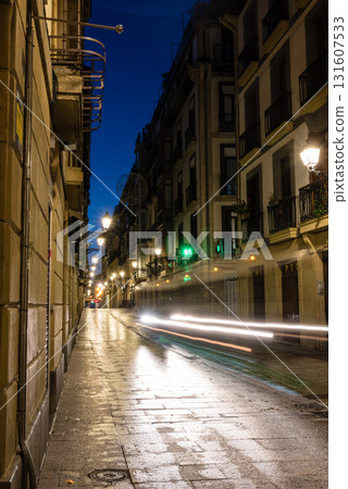 The old town of San Sebastian, Spain, before dawn: deserted cobblestone streets, streetlights and historic buildings The old town of San Sebastian, Spain, before dawn: deserted cobblestone streets, streetlights and historic buildings 131607533