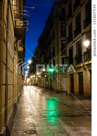 The old town of San Sebastian, Spain, before dawn: deserted cobblestone streets, streetlights and historic buildings The old town of San Sebastian, Spain, before dawn: deserted cobblestone streets, streetlights and historic buildings 131607534