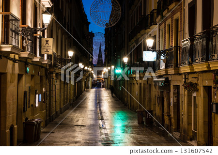 The old town of San Sebastian, Spain, before dawn: deserted cobblestone streets, streetlights and historic buildings 131607542