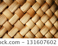 Closeup of woven bamboo texture showcases intricate pattern with natural brown and beige hues, creating rustic and organic feel 131607602