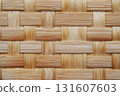 Close up of woven bamboo texture showcases light brown pattern with interlaced strips, creating natural and rustic appearance. intricate design highlights craftsmanship involved traditional 131607603