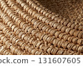 Close up of woven straw mat texture showcases intricate patterns and natural fibers, highlighting craftsmanship and earthy tones. detailed view emphasizes texture and structure 131607605