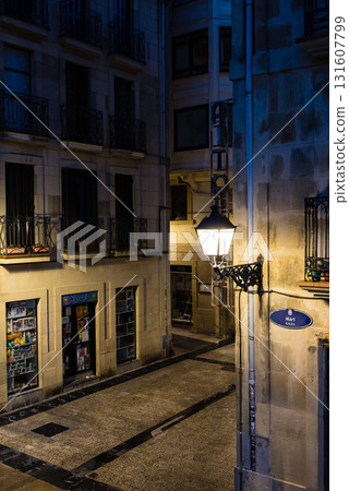 The old town of San Sebastian, Spain, before dawn: deserted cobblestone streets, streetlights and historic buildings The old town of San Sebastian, Spain, before dawn: deserted cobblestone streets, streetlights and historic buildings 131607799