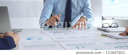 Business professionals study financial charts and graphs during corporate meetings, focusing on data manipulation and market planning Business professionals study financial charts and graphs during corporate meetings, focusing on data manipulation and market planning 131607801