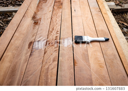 Paint brush and wood material in construction work. 131607883