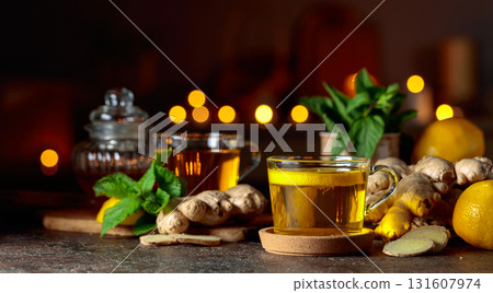 Cup of ginger tea with lemon, honey, mint, and ginger root. Cup of ginger tea with lemon, honey, mint, and ginger root. 131607974