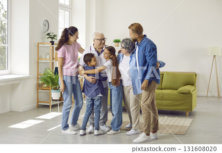 Big happy family of six members hugging together at home 131608020