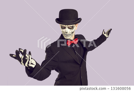 Man in skeleton costume does welcoming gesture and invites you to Halloween party Man in skeleton costume does welcoming gesture and invites you to Halloween party 131608056