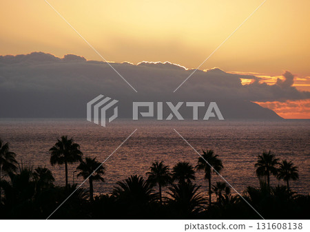 Sunset Over La Gomera island. View from Tenerife with Dramatic Clouds and Silhouetted Palms Sunset Over La Gomera island. View from Tenerife with Dramatic Clouds and Silhouetted Palms 131608138