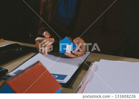 Customer signing a real estate contract in real estate agency. 131608226