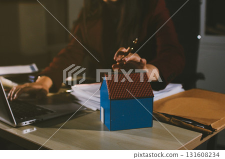 Customer signing a real estate contract in real estate agency. Customer signing a real estate contract in real estate agency. 131608234