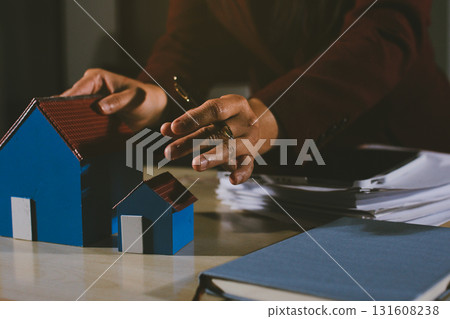 Customer signing a real estate contract in real estate agency. Customer signing a real estate contract in real estate agency. 131608238