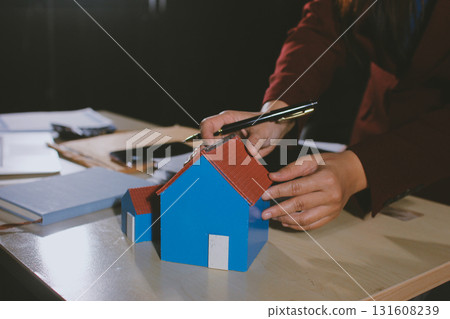 Customer signing a real estate contract in real estate agency. Customer signing a real estate contract in real estate agency. 131608239