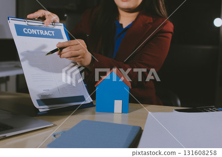 Customer signing a real estate contract in real estate agency. Customer signing a real estate contract in real estate agency. 131608258