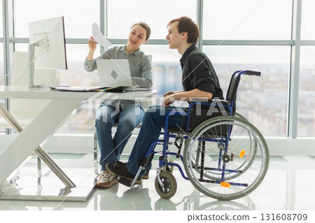 Colleagues business people woman man in chair for people with disability working on office. Startup business group team working together. Corporate professional team discussing project ideas 131608709