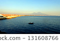 The Gulf of Naples at sunset with a boat in the middle of the sea and Vesuvius in the background. 131608766