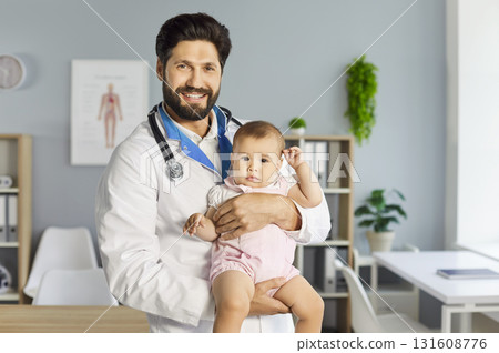 Man pediatrician holding small baby, examining during medical check up, trearting newborn in clinic 131608776
