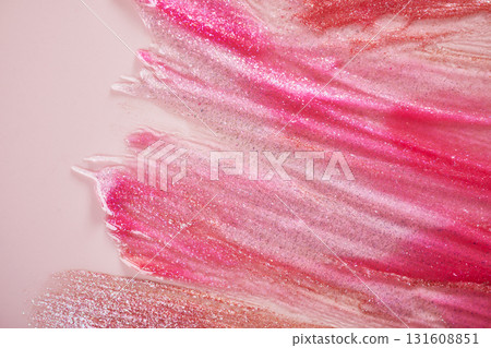 Vibrant pink and gold glitter brushstrokes on soft pink background 131608851