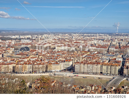 High-angle panoramic view of Lyon, France, from Fourviere Hill. The scene features the winding Saone river and the historic city center, dominated by red tiled rooftops High-angle panoramic view of Lyon, France, from Fourviere Hill. The scene features the winding Saone river and the historic city center, dominated by red tiled rooftops 131608926