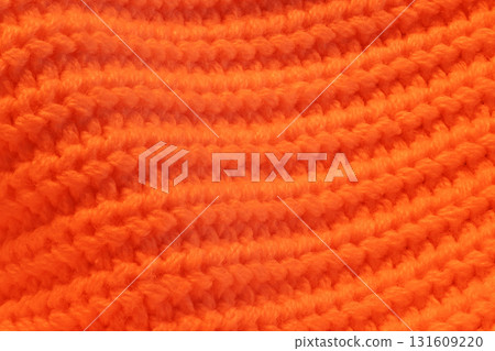 A close up of a knitted orange sweater A close up of a knitted orange sweater 131609220