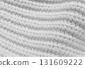 A close up of a white knit sweater 131609222