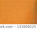 A brown cardboard background with a white dot in the middle 131609225