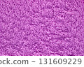 A purple towel with a fuzzy texture 131609229