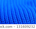 The blue knit sweater has a very soft and fuzzy texture 131609232