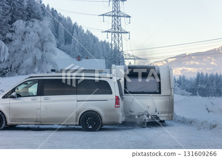 Scenic modern campervan motor home trailer van parked camper park site lot Austria at sunrise sunset Kaprun mountain landscape. Motorhome campground station travel destination. RV lifestyle Scenic modern campervan motor home trailer van parked camper park site lot Austria at sunrise sunset Kaprun mountain landscape. Motorhome campground station travel destination. RV lifestyle 131609266
