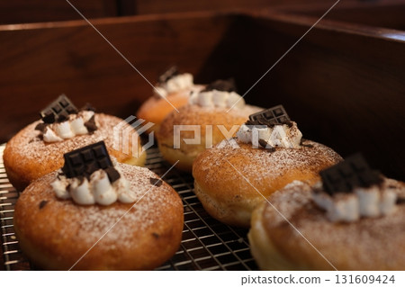 doughnuts scene - mix of multicolored sweet donuts with sprinkel on blue background doughnuts scene - mix of multicolored sweet donuts with sprinkel on blue background 131609424