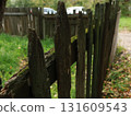 old wooden green fence fence next to the house 131609543
