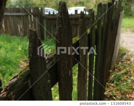 old wooden green fence fence next to the house 131609543