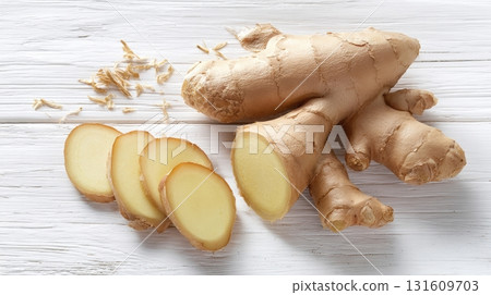 Fresh ginger root with sliced pieces on a rustic wooden background 131609703
