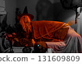 Witch with Halloween Pumpkin Doing Magic 131609809