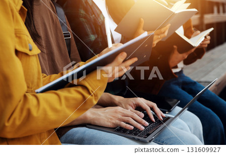 Happy students walking together on university campus, chatting and laughing outdoors after classes Happy students walking together on university campus, chatting and laughing outdoors after classes 131609927