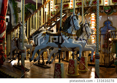 Vintage carousel horses. Colorful horses stand on carousel ride, showcasing intricate details of their painted designs and nostalgic charm of classic amusement park rides Vintage carousel horses. Colorful horses stand on carousel ride, showcasing intricate details of their painted designs and nostalgic charm of classic amusement park rides 131610278
