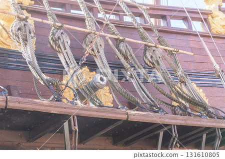 Old wooden vessel with details of rigging and artillery. Perfect for history, culture, military and sea themes. 131610805