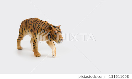 plastic toy tiger figure on a white background plastic toy tiger figure on a white background 131611098
