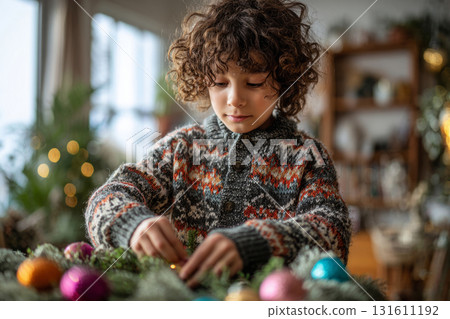 Child in knitted sweater holding decorated Christmas wreath with ornaments indoors 131611192