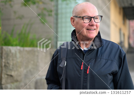 Portrait of a smiling senior man wearing sportswear in the city 131611257