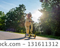 Scooter child. Girl riding scooter toddler. Yellow outdoor activity park road. 131611312