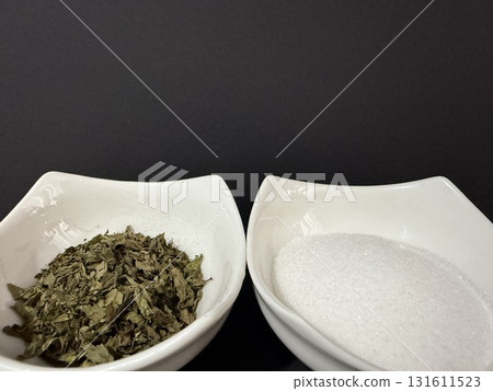 Bowls of mint tea and sugar on dark background. Bowls of mint tea and sugar on dark background. 131611523